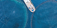 Service boat for feeding fish on offshore aquafarming fish farm in sea for cultivation fish